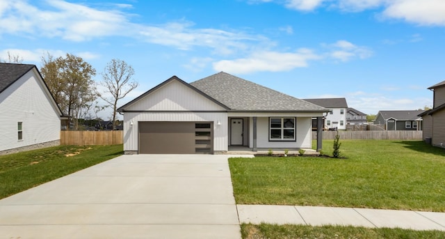 235 Donegal Dr, Clarksville, TN 37042 - view of front facade with fence, concrete driveway, a front yard, and an attached garage