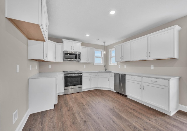 211 Donegal Dr, Clarksville, TN 37042 - kitchen with appliances with stainless steel finishes, a sink, dark wood-style floors, white cabinetry, and recessed lighting