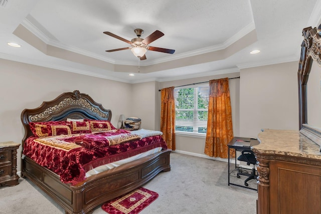 bedroom featuring crown molding, a tray ceiling, recessed lighting, and light colored carpet
