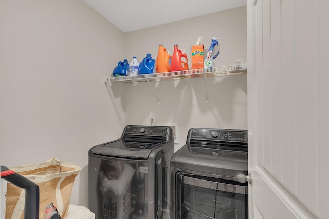 washroom with laundry area and washer and dryer