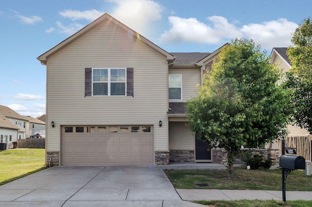 view of front of property featuring an attached garage, fence, driveway, and stone siding