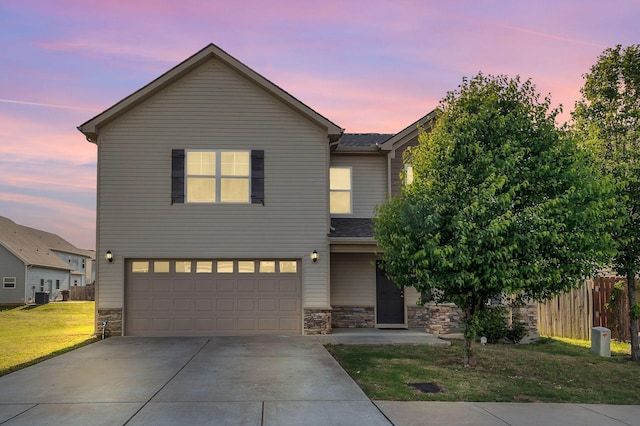 traditional home with a garage, fence, stone siding, central air condition unit, and driveway