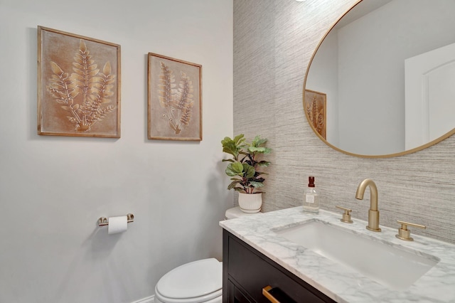 half bathroom featuring toilet and vanity
