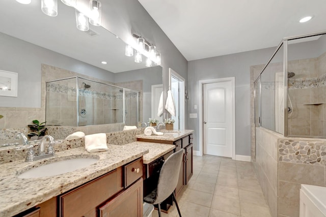 full bathroom with a stall shower, tile patterned flooring, and vanity