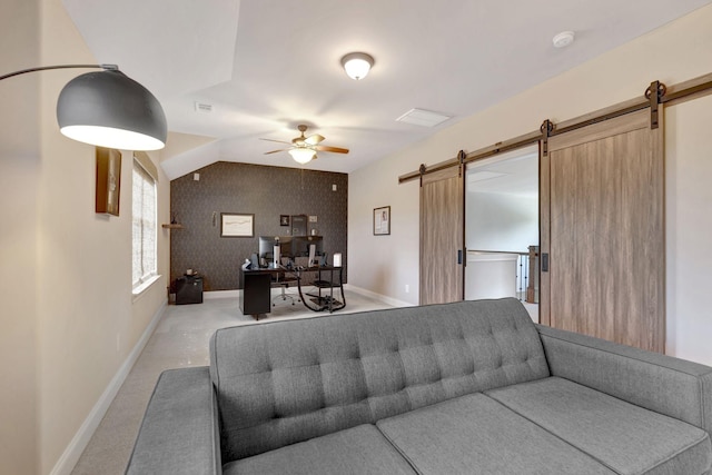 living room featuring light colored carpet, a barn door, vaulted ceiling, ceiling fan, and baseboards