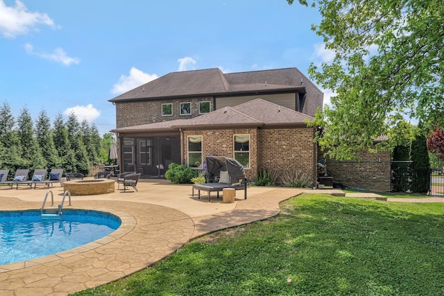 back of house with a patio, a yard, brick siding, and fence