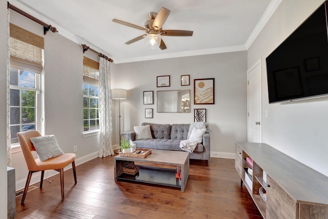 living room with baseboards, ornamental molding, a ceiling fan, and wood finished floors