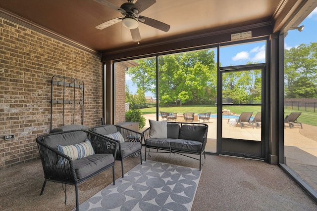 sunroom / solarium featuring ceiling fan and an outdoor hangout area