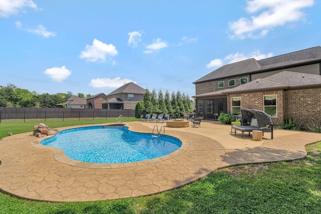 view of swimming pool with a patio area, a fenced in pool, a fenced backyard, a lawn, and a fire pit