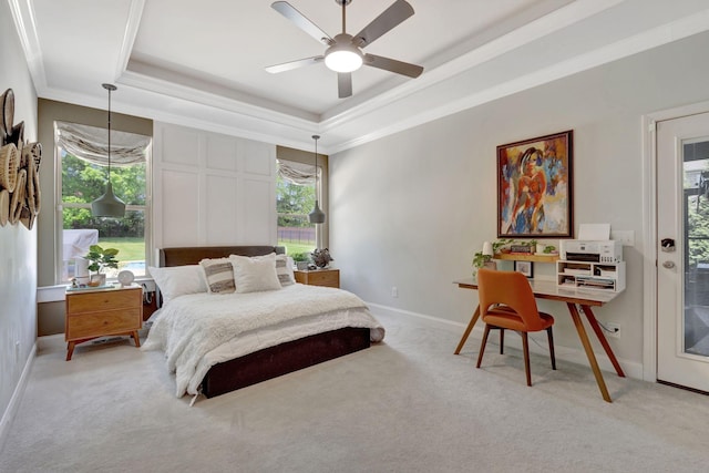 bedroom with multiple windows, carpet floors, and a tray ceiling