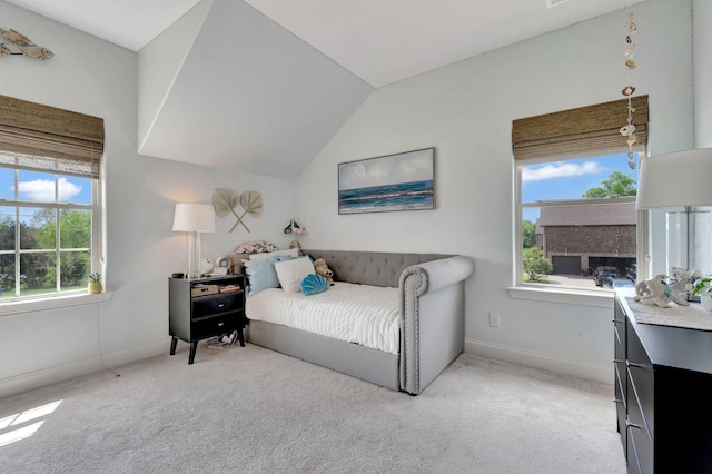 bedroom featuring lofted ceiling, baseboards, and light carpet