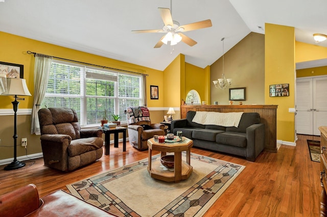 100 Treeann Ln, Ringgold, GA 30736 - living area with baseboards, high vaulted ceiling, wood finished floors, and ceiling fan with notable chandelier