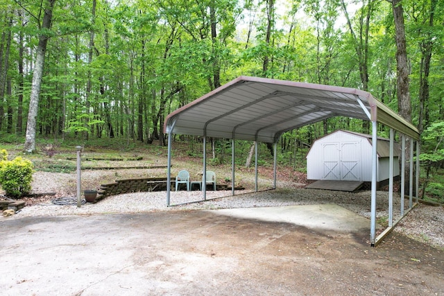 100 Treeann Ln, Ringgold, GA 30736 - view of car parking featuring a storage unit, a carport, driveway, and a forest view