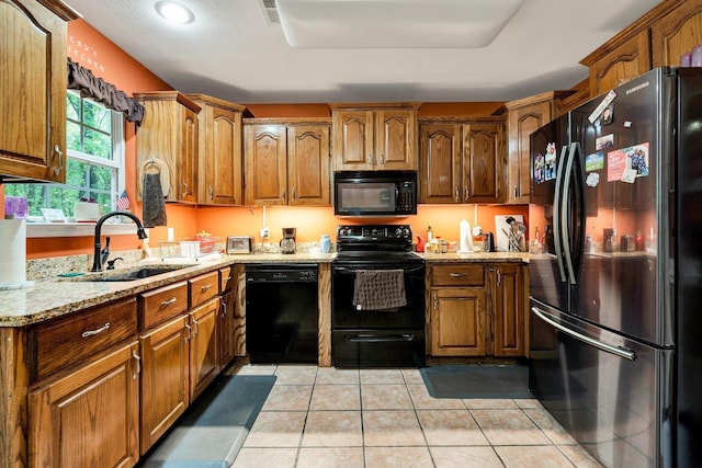 100 Treeann Ln, Ringgold, GA 30736 - kitchen with light stone countertops, a sink, brown cabinetry, black appliances, and visible vents