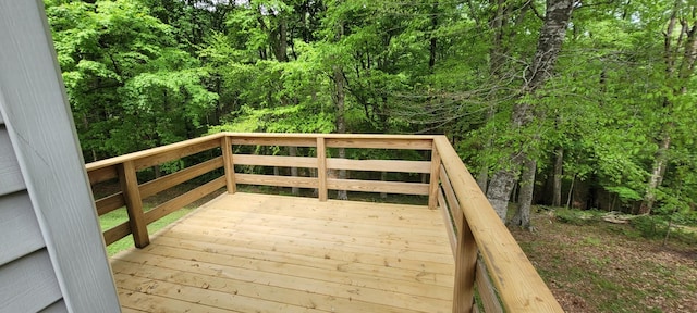 wooden deck with a wooded view