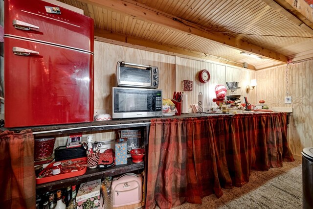 1308 Neelys Bend Rd, Madison, TN 37115 - interior space with carpet floors, wood walls, stainless steel microwave, and a toaster