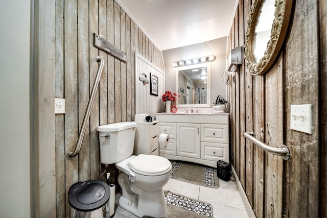 1308 Neelys Bend Rd, Madison, TN 37115 - bathroom with tile patterned flooring, wood walls, toilet, and vanity