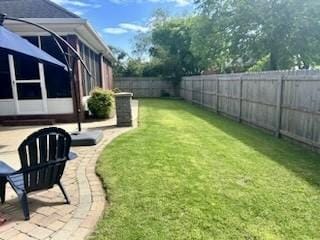 view of yard with a sunroom and a fenced backyard