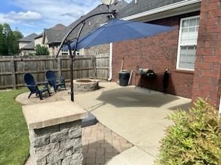 view of patio with a fire pit and fence