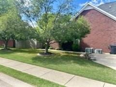 view of side of property with a lawn