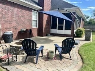 view of patio featuring fence and a sunroom