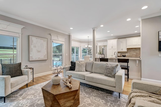 1199 Ben Hill Blvd, Nolensville, TN 37135 - living area featuring light wood finished floors, healthy amount of natural light, recessed lighting, crown molding, and a chandelier