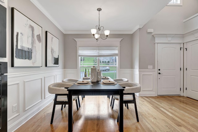 1199 Ben Hill Blvd, Nolensville, TN 37135 - dining room with a chandelier, light wood-style flooring, crown molding, a wainscoted wall, and a decorative wall