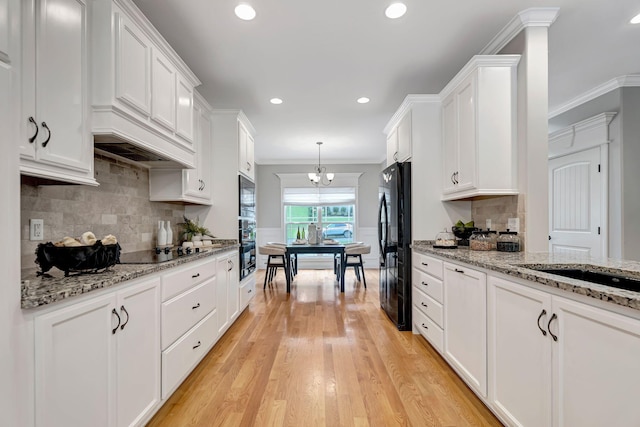 1199 Ben Hill Blvd, Nolensville, TN 37135 - kitchen with black appliances, white cabinets, decorative backsplash, crown molding, and recessed lighting