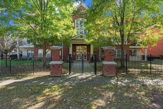 3201 Aspen Grove Dr Unit L8, Franklin, TN 37067 - view of front of house with brick siding, a fenced front yard, and a gate