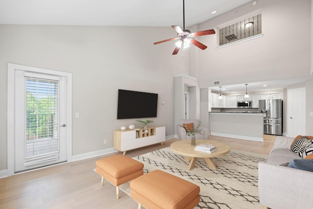 3201 Aspen Grove Dr Unit L8, Franklin, TN 37067 - living room with a towering ceiling, ceiling fan, baseboards, and light wood-style floors