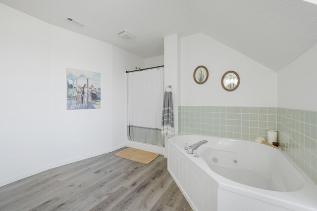 1883 Sawgrass Ln, Chapel Hill, TN 37034 - full bath with a tub with jets, wood finished floors, visible vents, and a stall shower