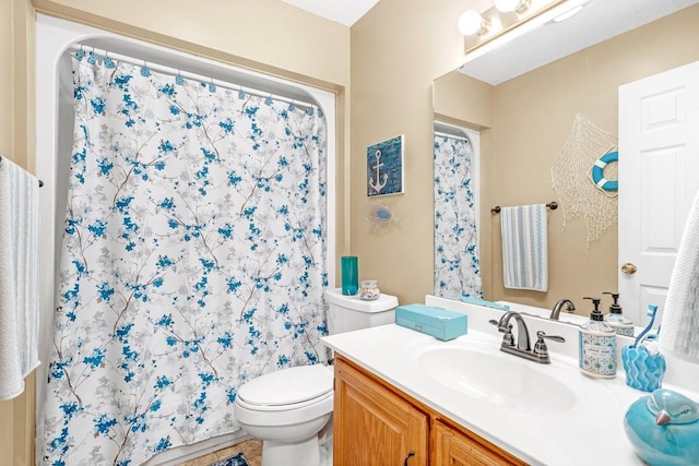 full bathroom with vanity, toilet, and curtained shower