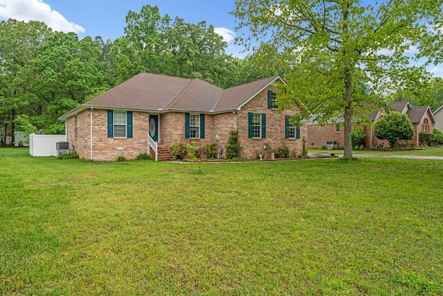 ranch-style house with a front yard, central AC unit, and brick siding