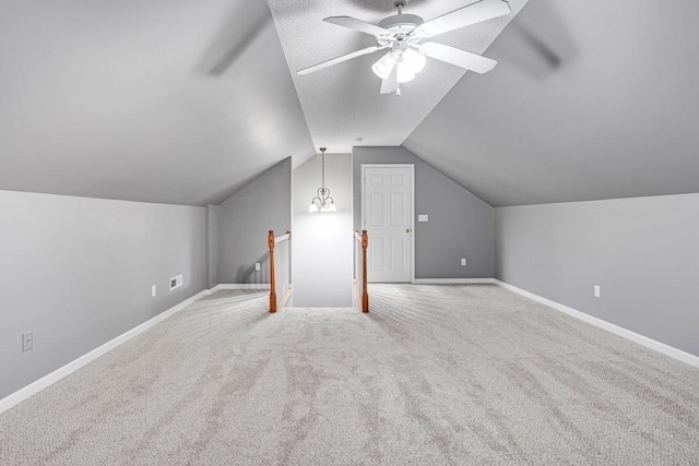 bonus room with baseboards, a ceiling fan, carpet, and vaulted ceiling
