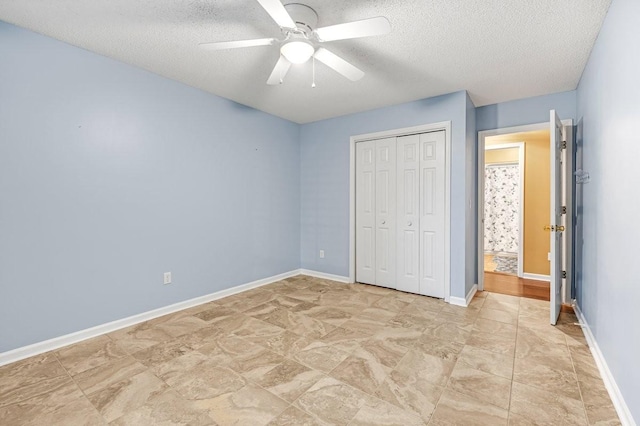 unfurnished bedroom featuring a textured ceiling, ceiling fan, baseboards, and a closet