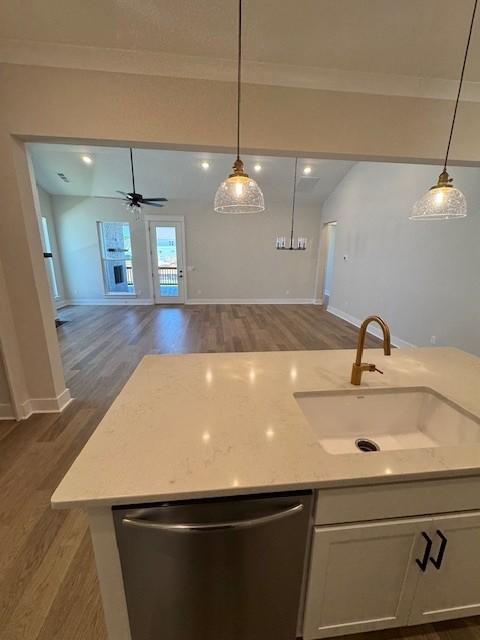 5738 Lennis Ln, Murfreesboro, TN 37129 - kitchen with stainless steel dishwasher, open floor plan, dark wood-type flooring, pendant lighting, and ornamental molding