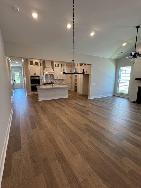 5738 Lennis Ln, Murfreesboro, TN 37129 - unfurnished living room featuring dark wood finished floors, a ceiling fan, recessed lighting, a fireplace, and lofted ceiling