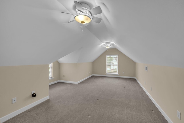 bonus room with lofted ceiling, ceiling fan, baseboards, and carpet floors