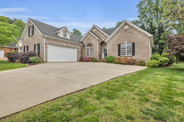 view of front of house with brick siding, a front yard, driveway, and an attached garage