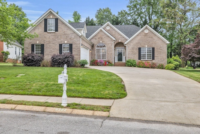 traditional home featuring a front lawn, driveway, and brick siding