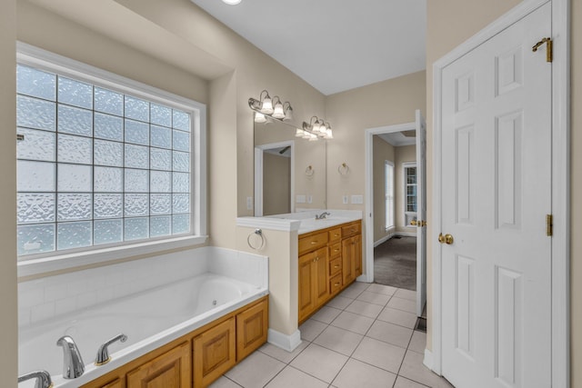 full bathroom featuring tile patterned floors, baseboards, a bath, and vanity