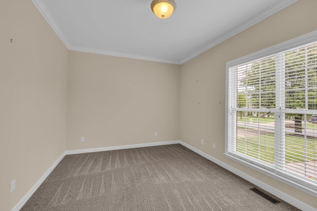 unfurnished room featuring crown molding, visible vents, and baseboards