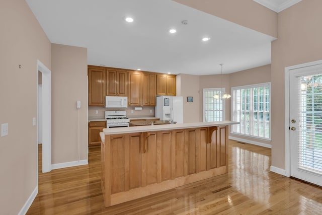 kitchen featuring recessed lighting, white appliances, light wood-style flooring, light countertops, and baseboards