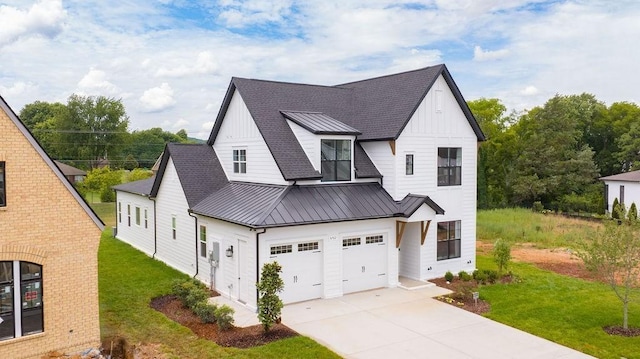 modern farmhouse style home featuring an attached garage, board and batten siding, metal roof, and a standing seam roof