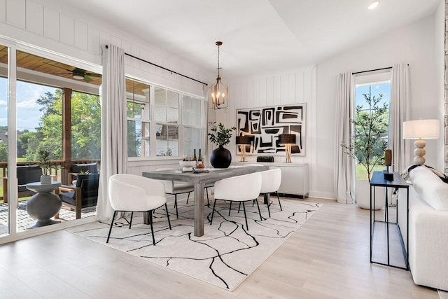 dining area featuring lofted ceiling, recessed lighting, wood finished floors, and a chandelier