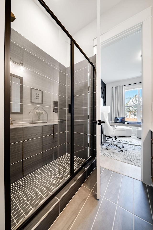 bathroom with tile patterned floors and a shower stall