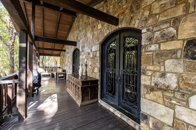 property entrance with french doors and stone siding