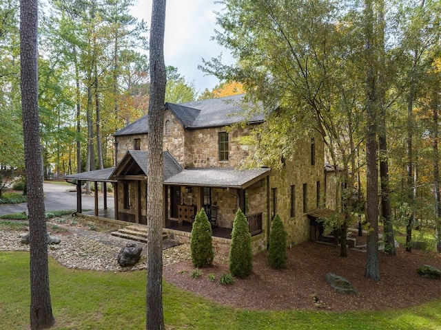 view of front of house with covered porch and stone siding
