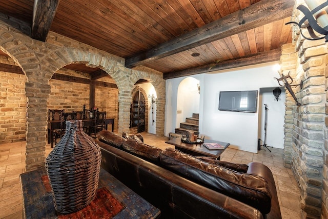living area featuring wood ceiling, beamed ceiling, and arched walkways