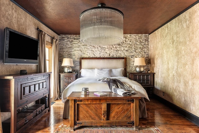 bedroom with hardwood / wood-style floors and baseboards